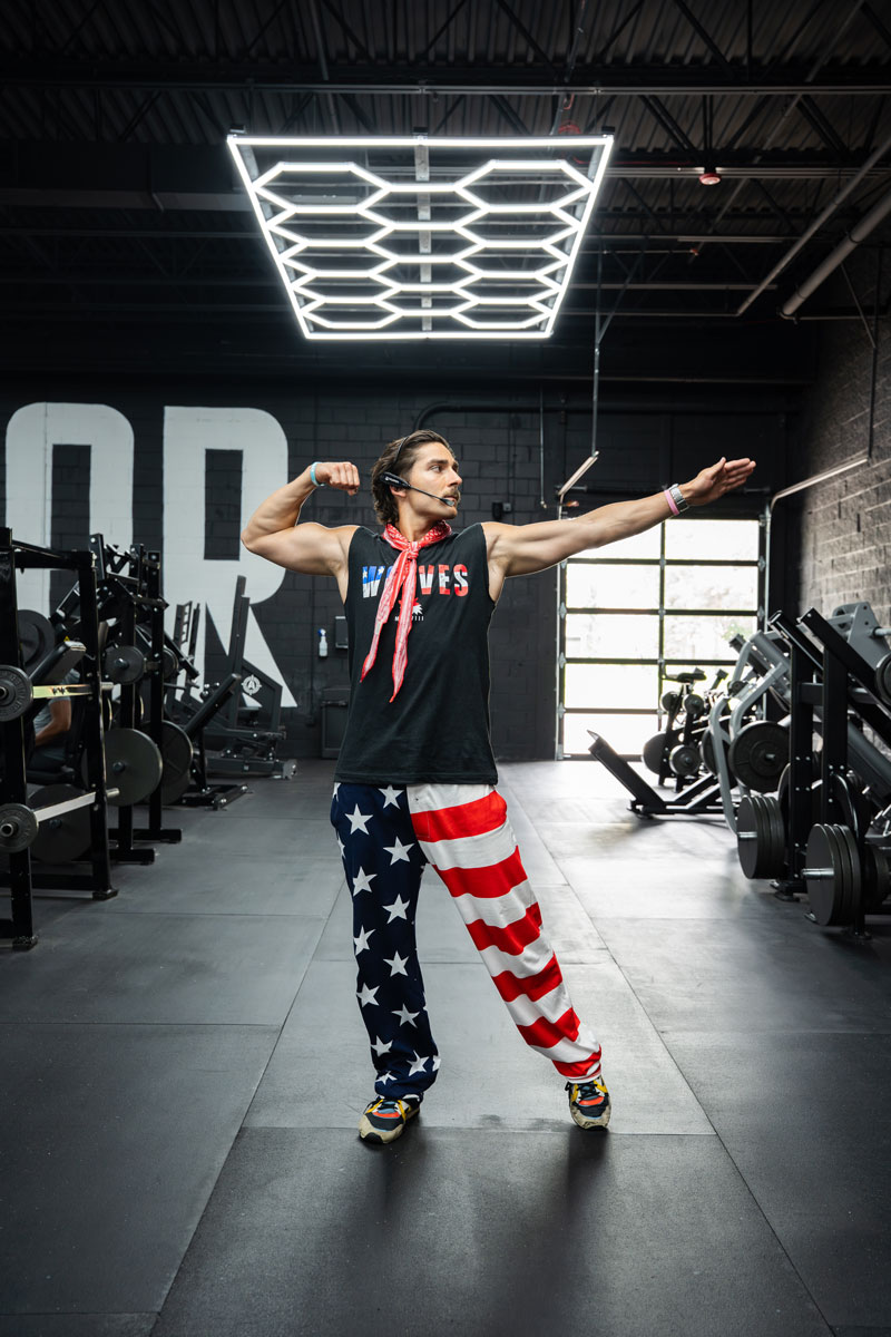 The coach is posing at the gym.